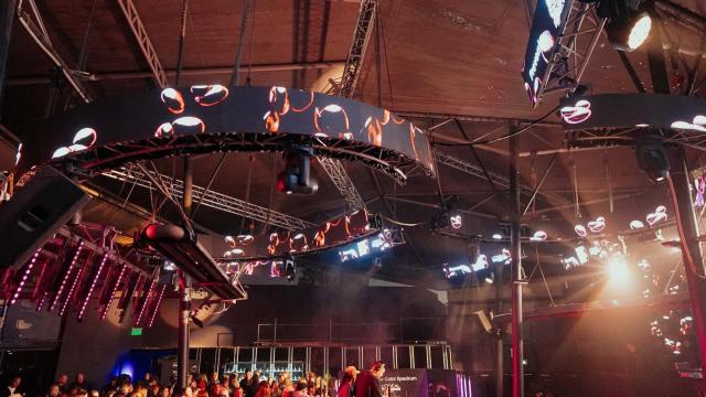 gente alrededor de un escenario interno con dj